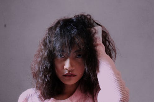 woman looking upset, playing with her hair