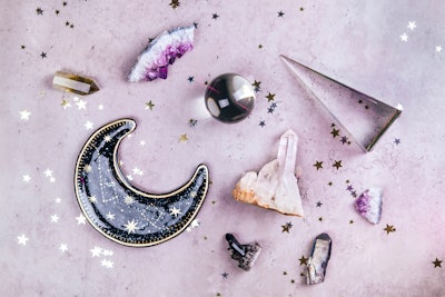 Magic set for rituals. Esoteric tools with crystal ball and many gemstone crystals on concrete gray ...