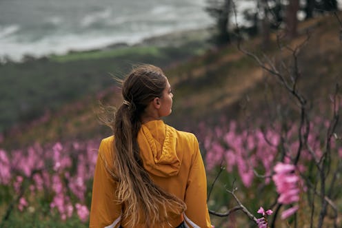 Woman walking through a flower field