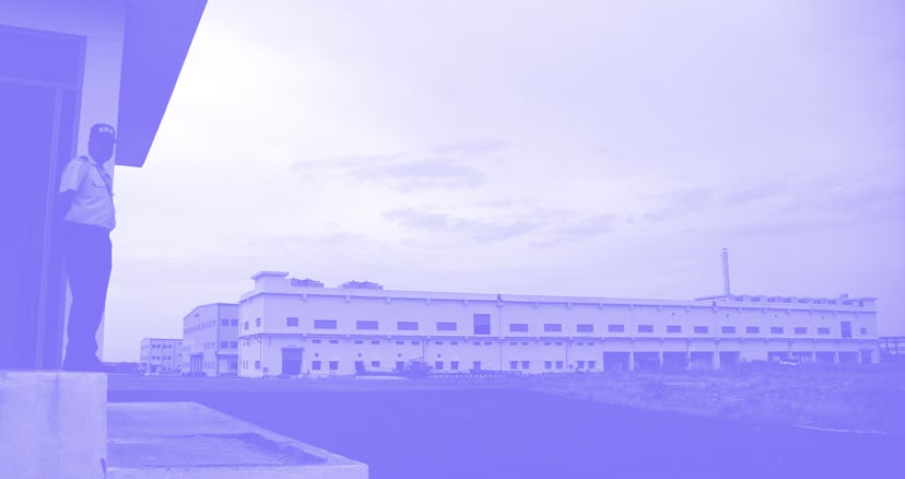 A security guard stands at the entrance of a factory operated by Taiwan-based IT giant Foxconn at Sr...