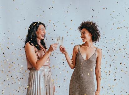 Two women drink champagne and use Prosecco captions and prosecco lyrics for their NYE Instagram phot...