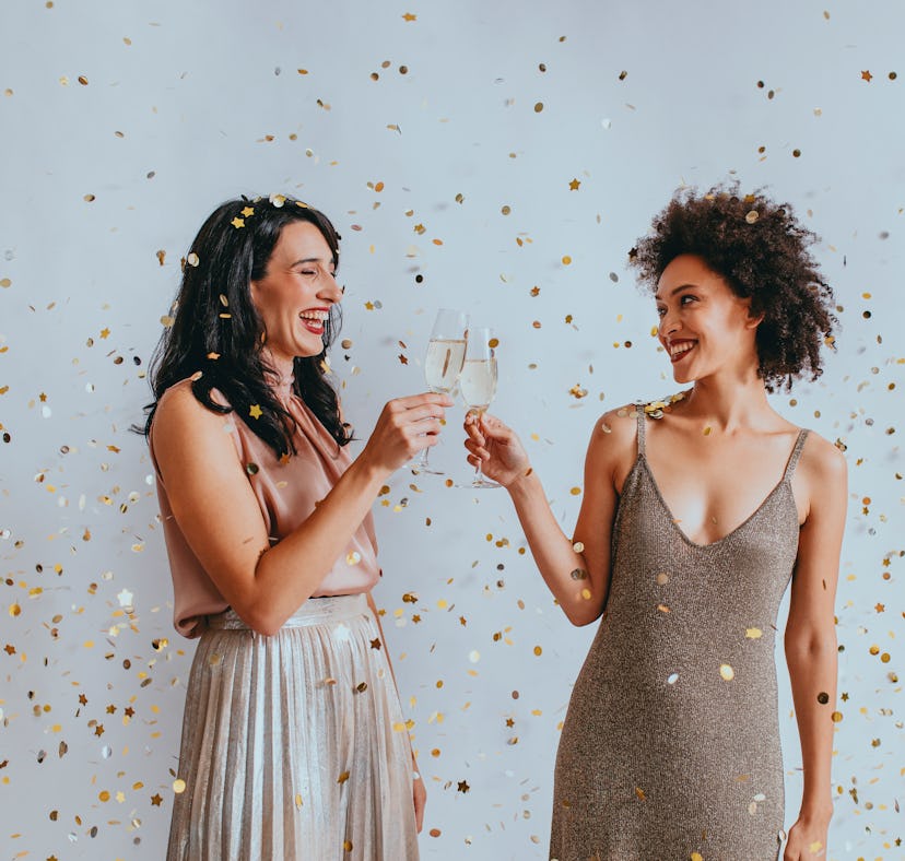 Two women drink champagne and use Prosecco captions and prosecco lyrics for their NYE Instagram phot...