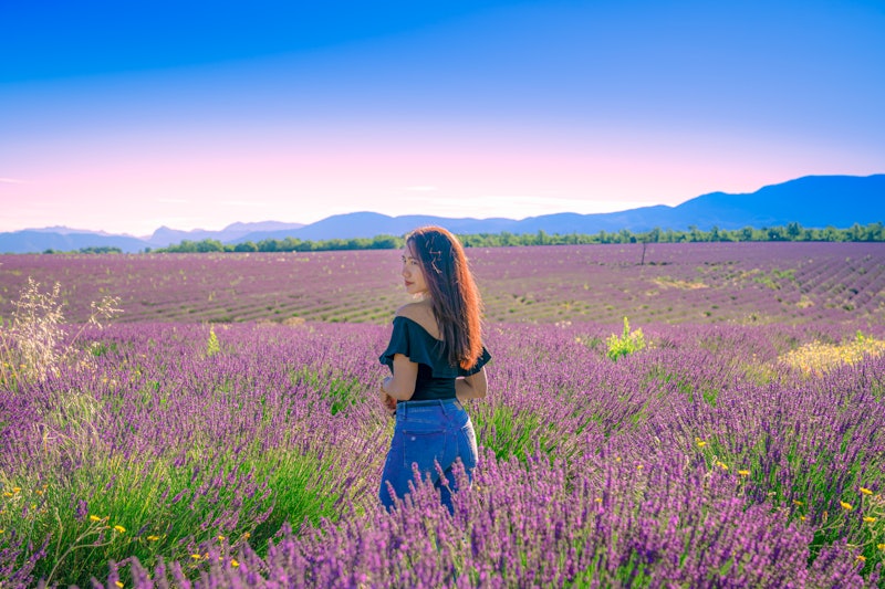 Woman enjoying lavender field.