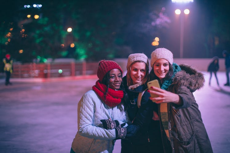 Photo of a cheerful friends making a selfie from a ice-skating rink, which is a birthday winter idea...