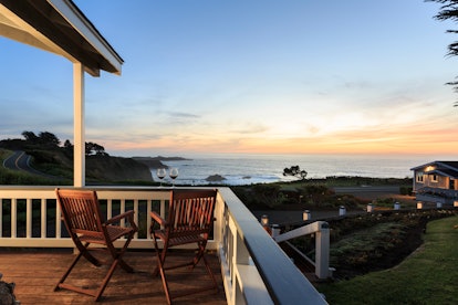Cottage with Deck, chairs and wine overlooking  sunset over Pacific Ocean , Sea Rock Inn, Mendocino,...