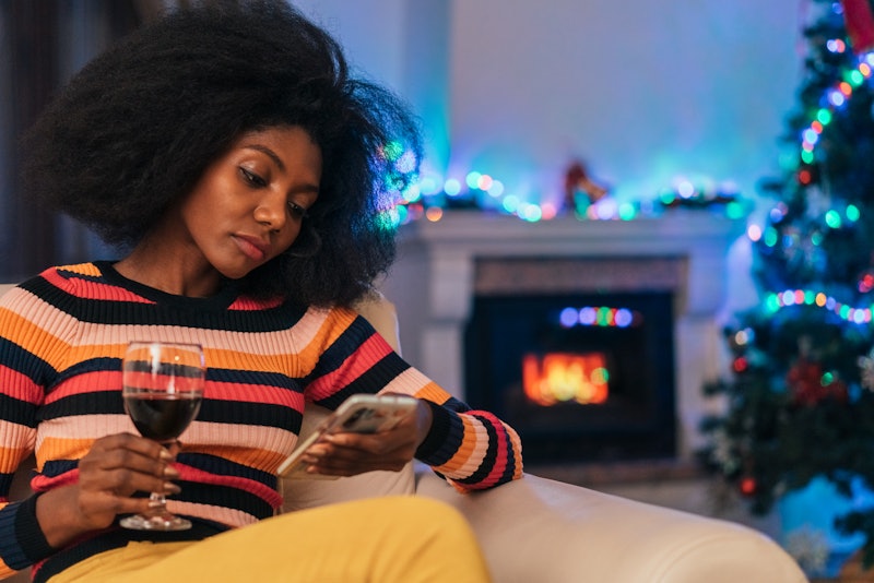 Woman sitting at the sofa and downloading someone else's Instagram story.