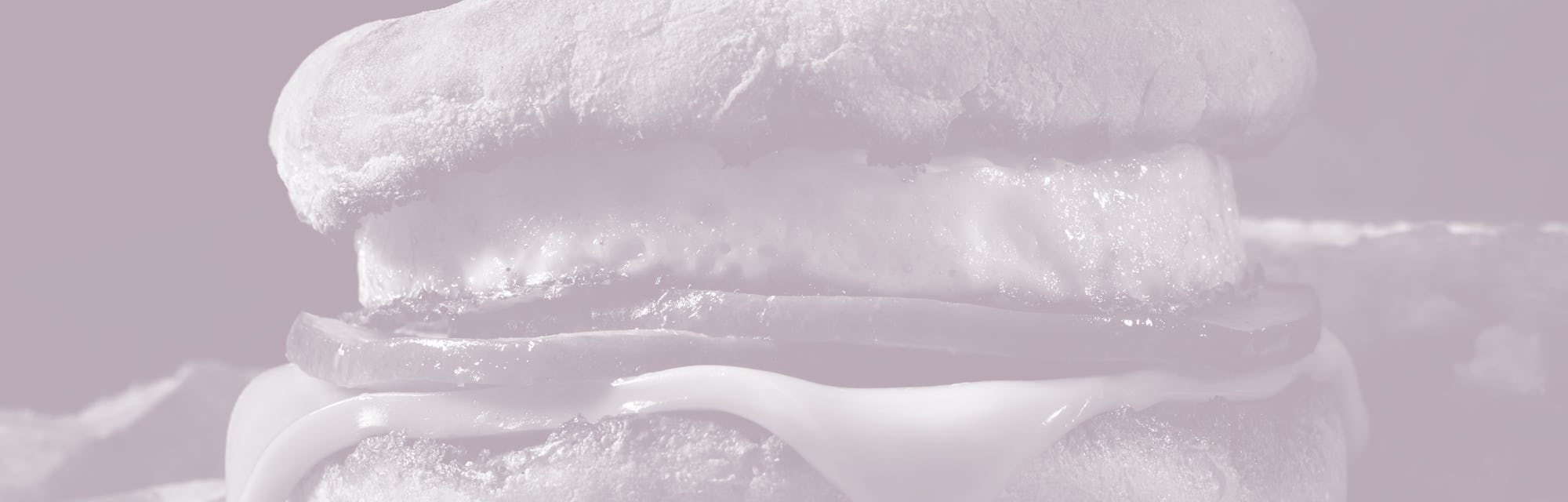 Classic Ham and Egg Breakfast Sandwich with Cheese on a Toasted English Muffin with Hash Brown Patti...