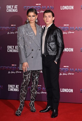 Zendaya and Tom Holland posing at a photocall for "Spiderman: No Way Home" 