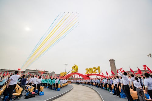 BEIJING, CHINA - JULY 01: Military jets fly over the Tiananmen Square in celebration of the 100th an...