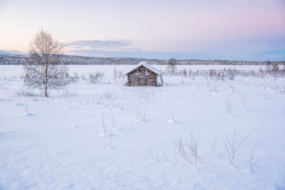 Cabin in a cold winter landscape in Lapland inside the Arctic Circle in Finland