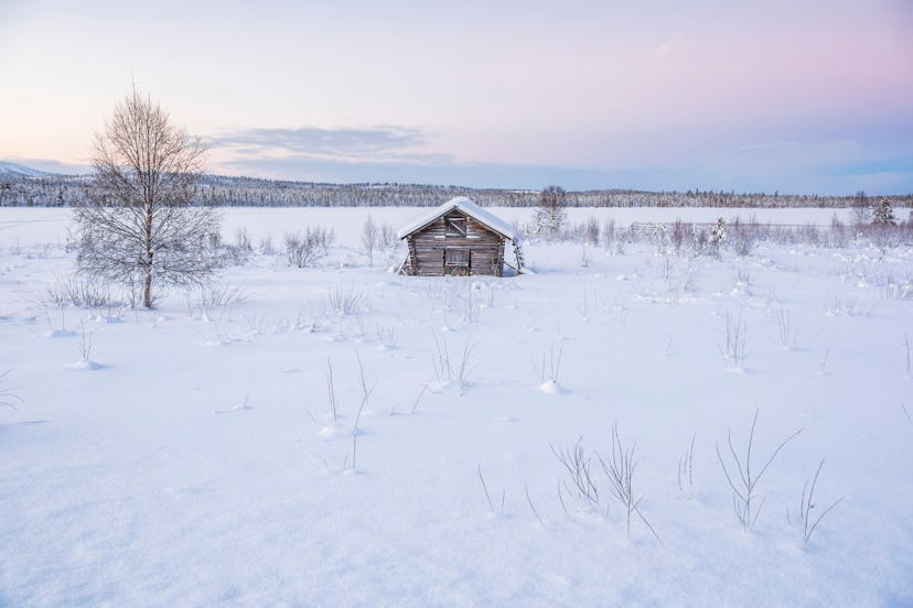 Cabin in a cold winter landscape in Lapland inside the Arctic Circle in Finland