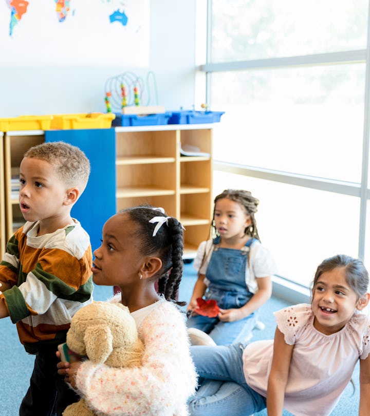 what to tip day care teachers like this woman giving young children one-on-one instructions.