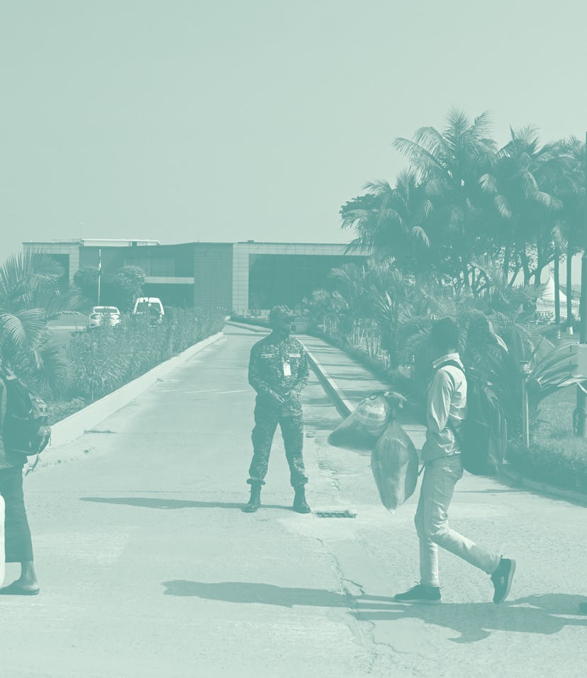Rohingya refugees walk in a queue as they get off from a bus to be relocated to Bhashan Char island ...