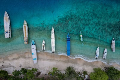 This aerial picture taken on November 22, 2021 shows boats anchored along an empty beach on Gili Tra...