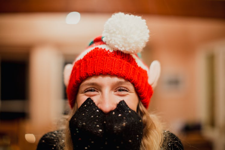 A woman wearing an elf hat may want some elf quotes and elf Instagram captions to post photos.