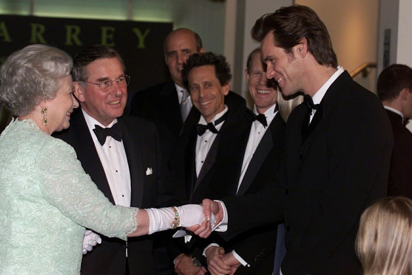 Queen Elizabeth II, meets American actor Jim Carrey, star of the film "Grinch"  before attending the...
