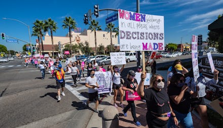 FULLERTON, CA - OCTOBER 02: Hundreds carrying signs make their way along Harbor Boulevard through do...