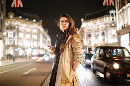 A woman in London at night is a travel trend and prediction for 2022, according to experts. 