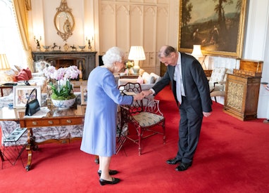 Britain's Queen Elizabeth II presents English concert organist Thomas Trotter with the Queen's Medal...