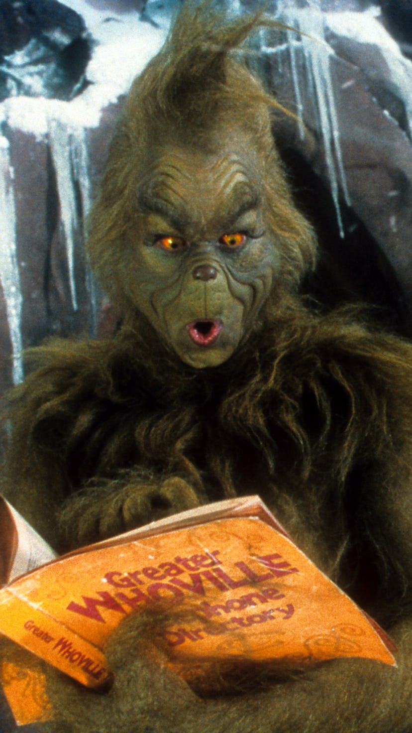 Jim Carrey looking through phone directory in a scene from the film 'How The Grinch Stole Christmas'...