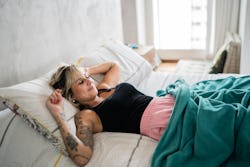Woman sleeping on the bed at home. Here's your daily horoscope for December 10, 2021.