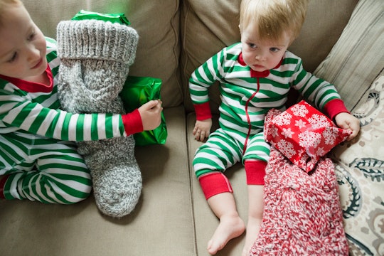 little kids in christmas pajamas with stockings