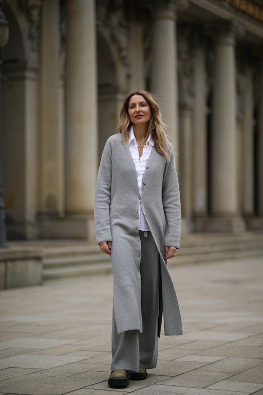 Sue Giers wearing a grey long cardigan and matching knit pants.