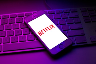 SPAIN - 2021/10/13: In this photo illustration a Netflix logo seen displayed on a smartphone on top ...