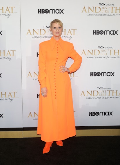 Cynthia Nixon wears orange Christopher John Rogers Resort 2022 dress.