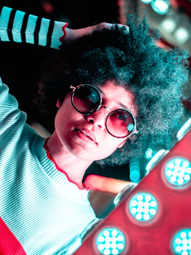 Young woman posing with sunglasses, thinking about the spiritual meaning of the January 2022 new moo...