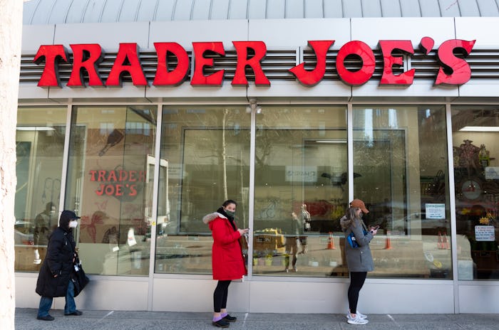 NEW YORK, NEW YORK - MARCH 19: People stand in line outside Trader Joe's in Kips Bay amid the corona...