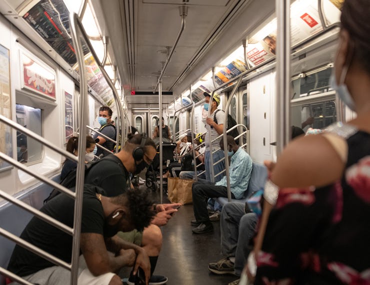 NEW YORK, NEW YORK - JULY 02: The view of people wearing masks inside a busy subway car as the city ...
