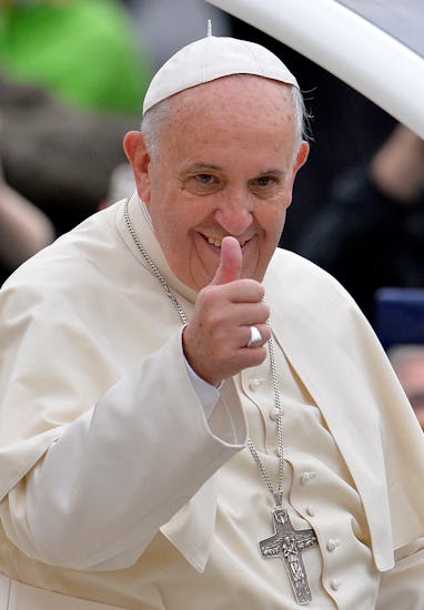 Pope Francis gives a thumbs-up as arrives for his weekly open-air general audience in St. Peter's Sq...