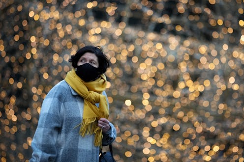 MANCHESTER, UNITED KINGDOM - DECEMBER 08: A woman wears a Covid-19 face mask as she walks past Chris...