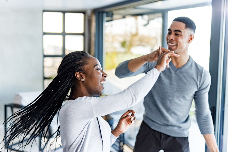 A happy couple dances in their bright home on Valentine's Day.