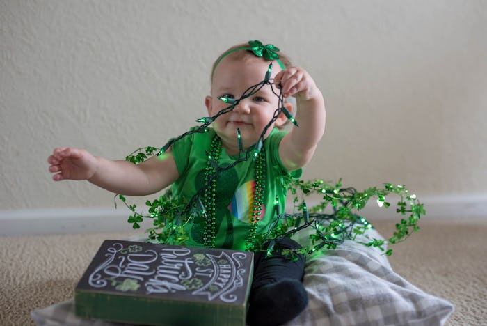baby playing with st patrick's day decorations