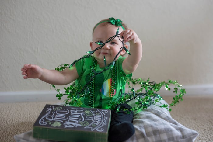 baby playing with st patrick's day decorations