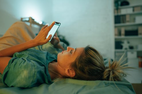 A woman on her phone customizes her Hive profile.