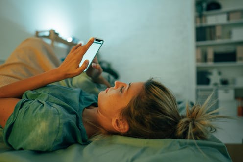 A woman on her phone customizes her Hive profile.