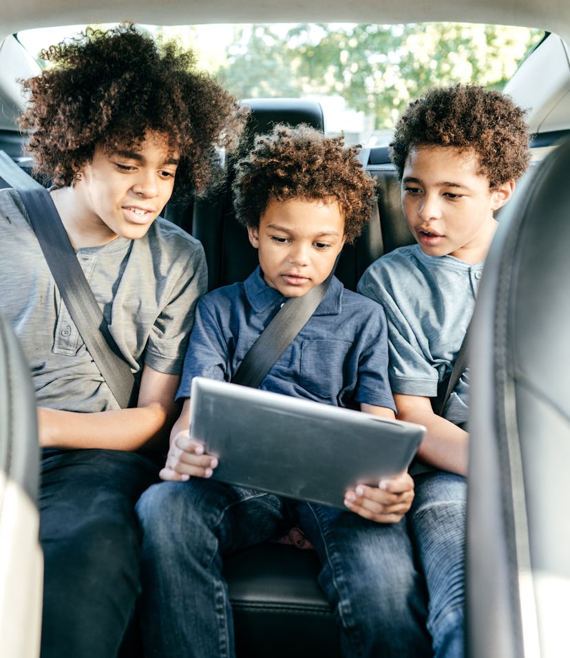 three brothers in backseat of car