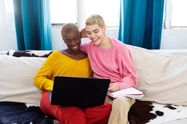 A couple sits on a couch while attending a virtual Black History Month event.