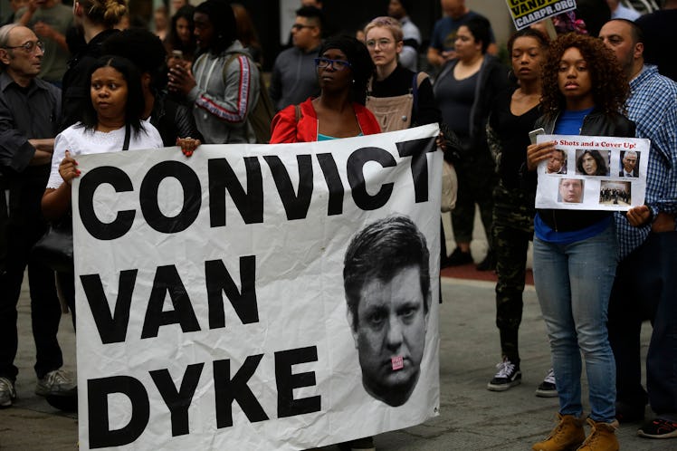 Protestors holding a sign saying "Convict Van Dayke"