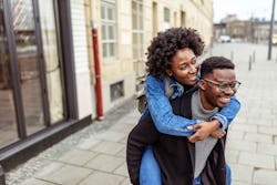 A man gives a woman a piggy-back ride. What does a past life mean? Psychics explain how to tell if s...