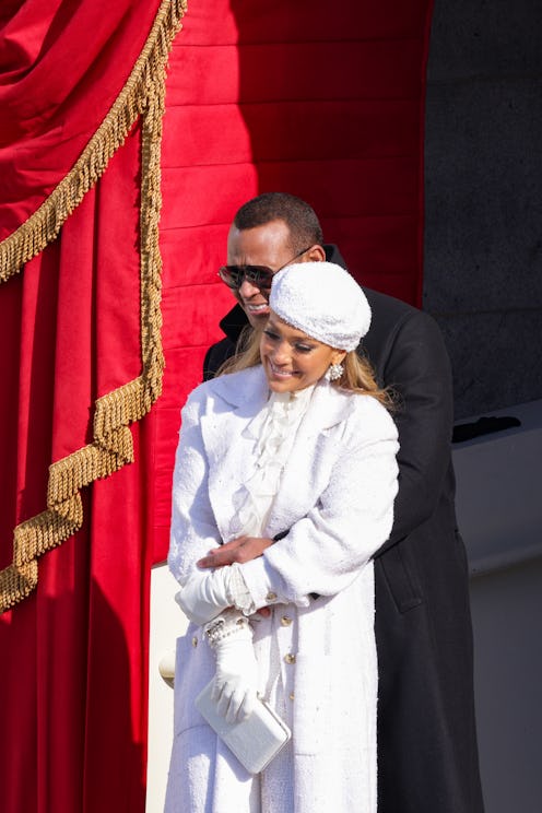 Jennifer Lopez on Valentine's Day, wearing a long white coat, white gloves, a white cap and crystal ...