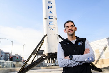 Jared Isaacman standing in front of a SpaceX rocket.