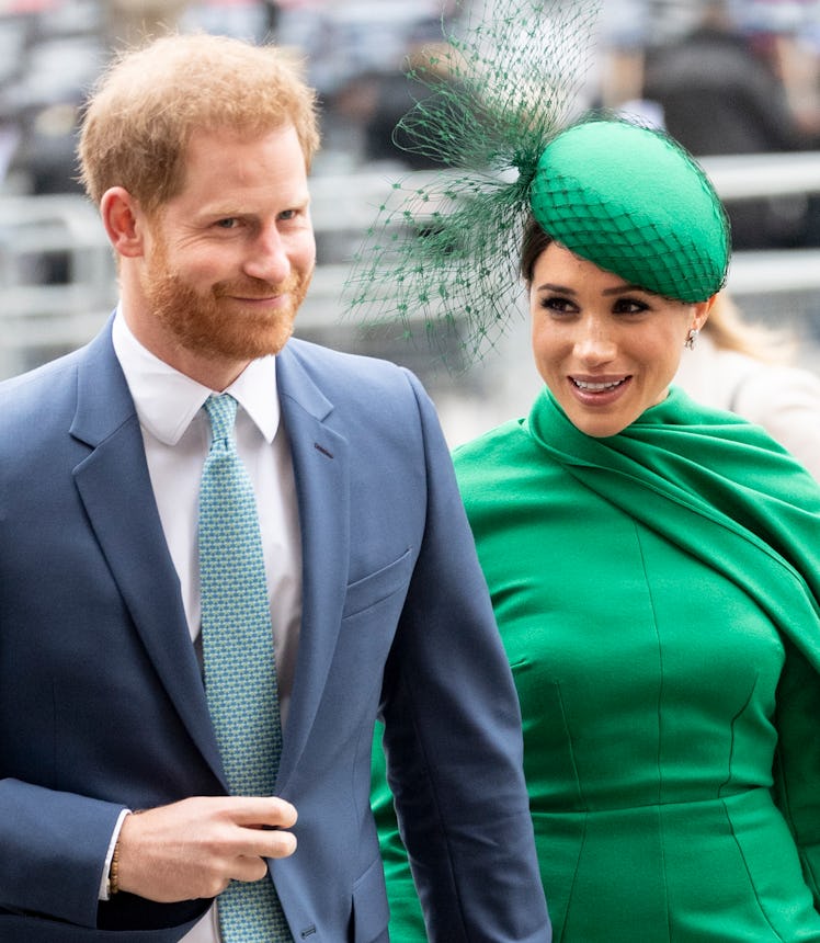 Prince Harry and Meghan Markle walk hand-in-hand.