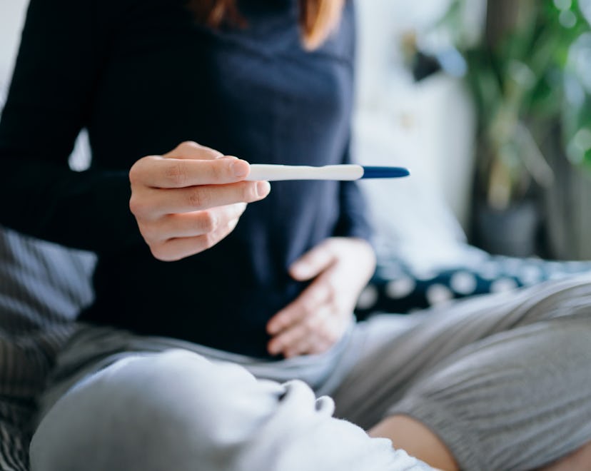 woman looking at pregnancy test, what if the line vanishes