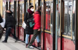 A person wears a mask while boarding a train. You might be able to travel safely after getting your ...