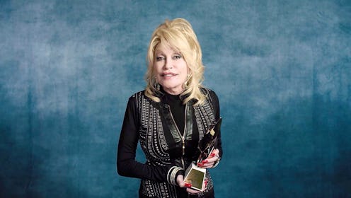 Dolly Parton holding Billboard's first-ever Hitmaker Award