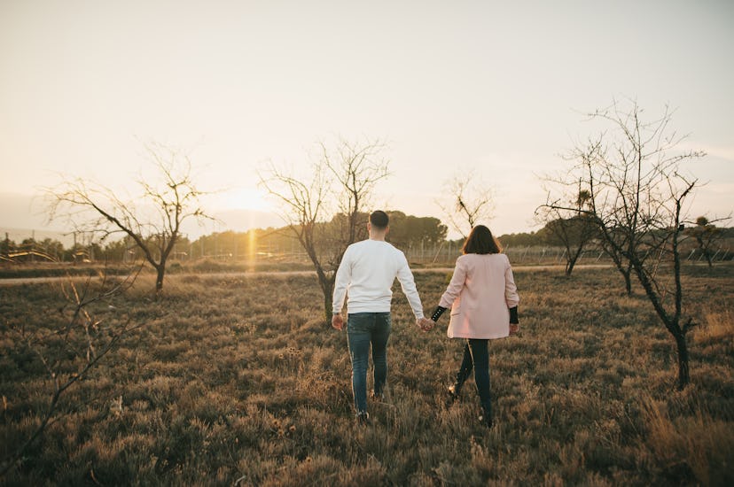 couple walking and holding hands in winter